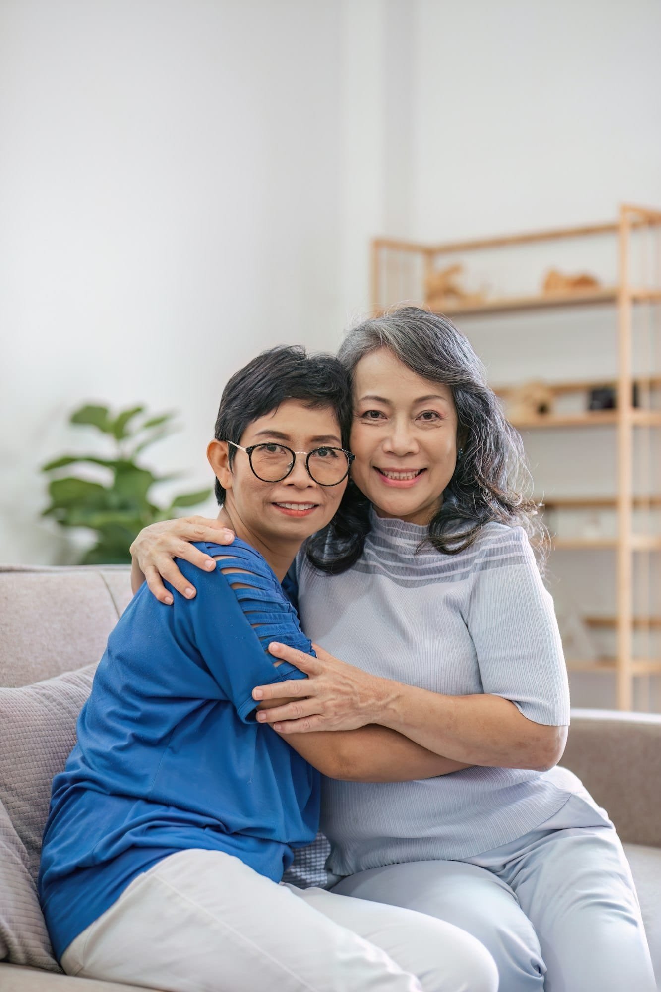 two women sitting on a couch